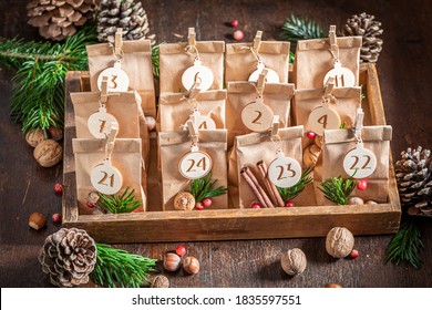 Original Christmas Advent Calendar made of paper bag and clip on wooden table