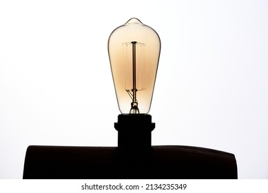 Original Circular Light Bulb Turned Off On White Background In Art Studio Photo 