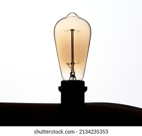 Original Circular Light Bulb Turned Off On White Background In Art Studio Photo 