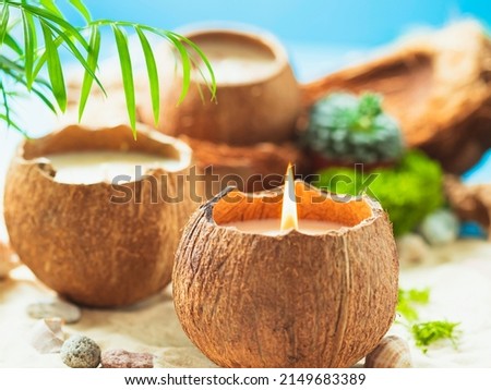 Original decorative handmade natural soy wax candle in a coconut. Candle in a coconut shell. Spa aroma candlet. Close up.