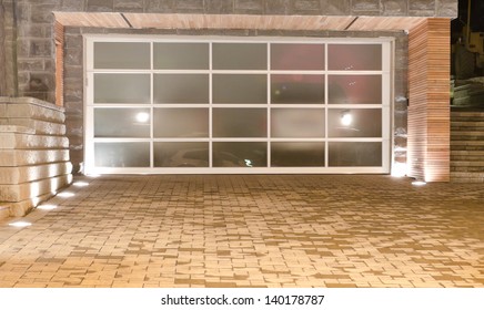 Original (glass) Double Doors Garage With Nicely Paved Long Driveway. Night (dick) Time. North America.