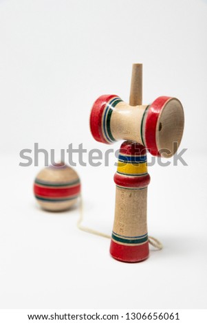 The original Kendama. An ancient, traditional, wooden Japanese skill toy for children. Has three cups and a spike which fits into the hole in the ball. Isolated on white background.