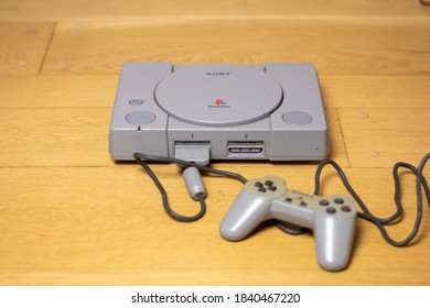 An Original Playstation 1, By Sony, On A Wooden Floor.