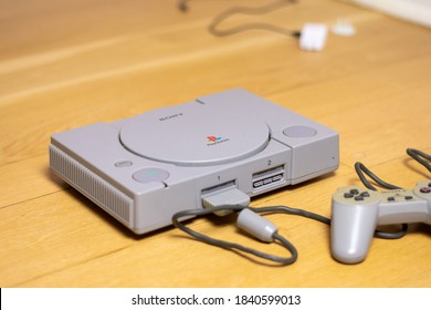 An Original Playstation 1, By Sony, On A Wooden Floor.