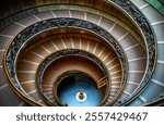 The original Staircase, with its iconic spiraling structure featuring herringbone paving, was built in 1505, while the modern one, was built in 1932 in Vatican City, Italy, 