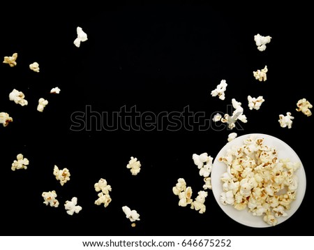 Similar – woman with popcorn in hand on yellow background. Copyspace