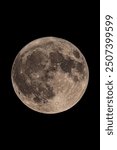 An original vertical photograph of the super blue moon on 19th of August 2024 with dark night background - full moon  supermoon as seen through a telescope