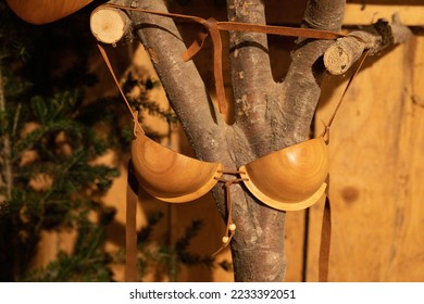 The original wooden bra with leather doors hangs on a wooden stand