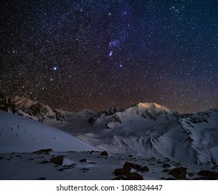 Orion constellation above the mountain peaks
