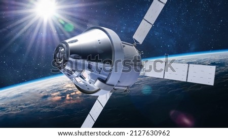 Orion spacecraft flight in space on orbit of Earth. Sci-fi wallpaper. Artemis space program. Expedition to Moon. Spaceship with astronauts. Elements of this image furnished by NASA 