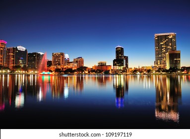 Orlando Downtown Skyline Panorama Over Lake Eola At Night With Urban Skyscrapers And Clear Sky.