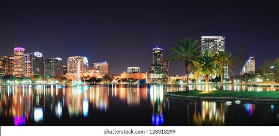 Orlando Downtown Skyline Panorama Over Lake Eola At Night With Urban Skyscrapers And Clear Sky.