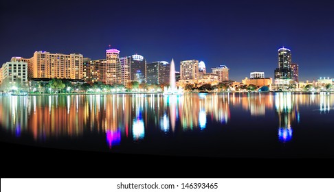 Orlando Downtown Skyline Panorama Over Lake Eola At Night With Urban Skyscrapers And Clear Sky.