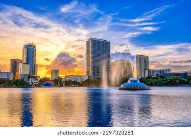 ORLANDO FL, US - May 24, 2022: Sunset and clouds over the Orlando skyline and fountain at Lake Eola Park, Orlando FL