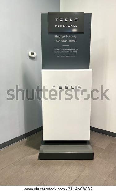 Orlando,\
FL USA - November 5, 2021:  The Tesla Powerwall and Sign at the\
entrance of the Tesla dealership in Orlando,\
FL.