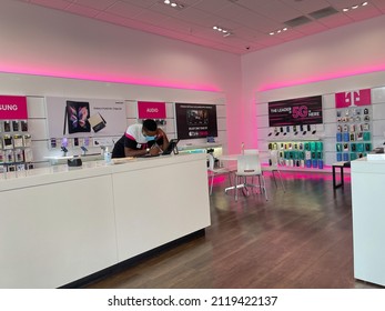 Orlando, FL USA - October 19, 2021: A T Mobile Employee Helping A  Customer On The Phone At A T Mobile Store In Orlando, Florida.