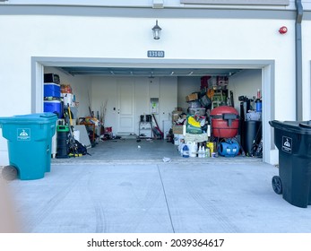 Orlando, FL USA -  September 3, 2021: An unorganized garage filled with a lot of stuff in a neighborhood.