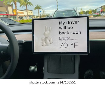 Orlando, FL USA-November 19, 2021: A Tesla Set On Dog Mode To Keep The Air Conditioning On For The Car Owners Canine Companion While They Are Parked In A Parking Lot.