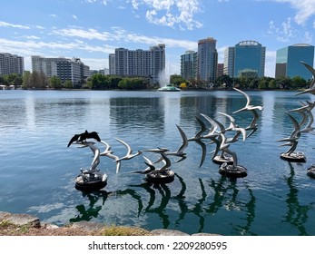 Orlando, Florida - 04, 2022: Lake Eola Park In Downtown Orlando, Florida. Large Commercial Buildings In The Background.