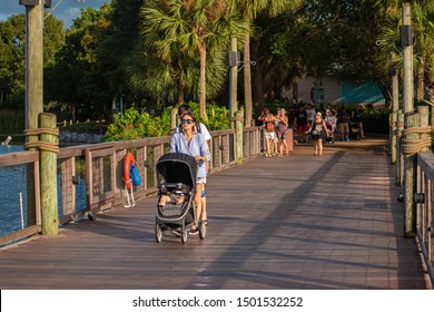 Orlando, Florida. August 31, 2019. Japanese Family Walking On Seven Seas Lagoon Bridge At Seaworld