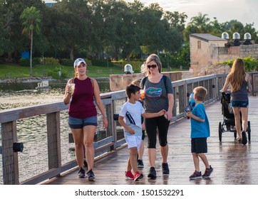 Orlando, Florida. August 31, 2019. People Walking On Seven Seas Lagoon Bridge At Seaworld 2