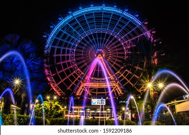 Orlando, Florida. December 13, 2019. Illuminated big wheel with colorful fountain in International Drive area 6