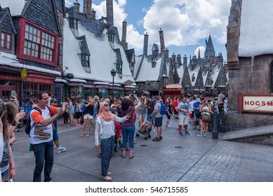 ORLANDO, FLORIDA - MAY 06, 2015: Butterbeer and Harry Potter Hogsmeade in Universal Orlando, Florida. People Doing Selfies.