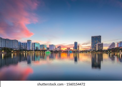 Orlando, Florida, USA Downtown City Skyline From Eola Park At Dusk.