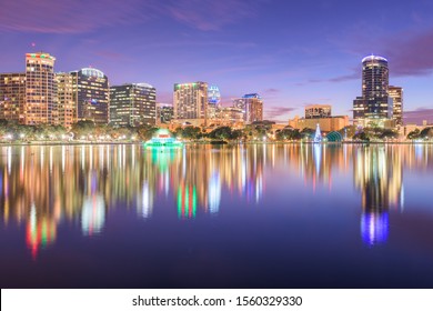 Orlando, Florida, USA Downtown City Skyline From Eola Park At Dusk.