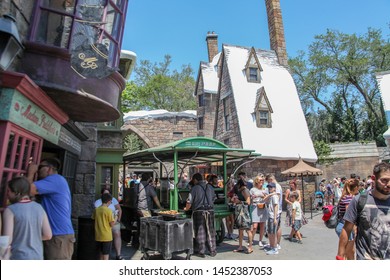 Orlando, Florida, USA, October 26, 2019: Hogsmeade, Diagon Alley, Snow-covered Architecture Littered With Harry Potter Bookstores And Movies. People Food Court, Trade. Convenience