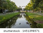 Orlando, Florida, USA - September 10, 2019: Canal separating the left-hand right side of Water Street. Celebration is a planned community in Osceola County, developed by The Walt Disney Company.