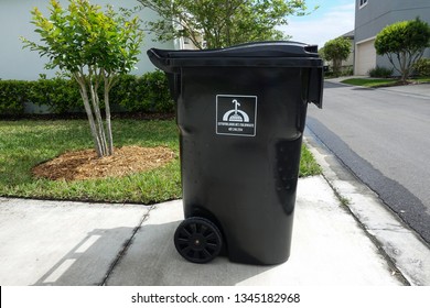 Orlando, FL/United States - 03/20/19:  Full Garbage Bin Waiting For The Garbage Truck To Collect The Garbage.