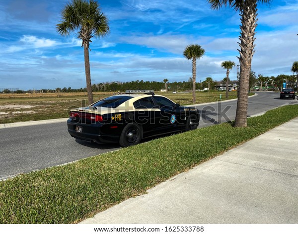 Orlando, FL/USA-1/23/20: A Florida Highway\
Patrol car parked on a neighborhood street in Laureate Park in\
Orlando, Florida.