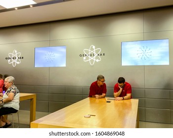 Orlando, FL/USA-12/6/19: An Apple Store Employee Helping A Customer With An Issue He Is Having With His IPad At The Genius Bar.