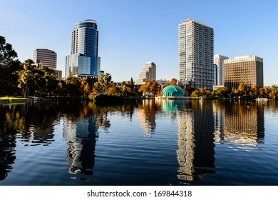 Orlando Lake Eola in the afternoon with urban skyscrapers and clear blue sky.