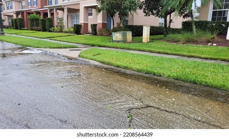 Orlando, September 29 2022 - Neighborhood Flooding Through Overflown Swale And Drainage In Street Coming To Neighboorhood