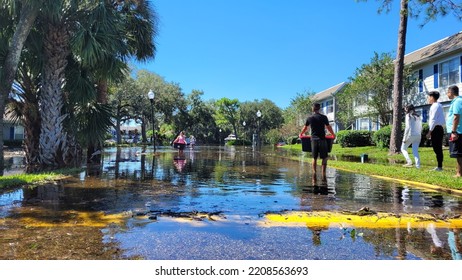 Orlando, September 30 2022 - People Victim Of Flooding By Hurricane Ian Victim Carrying Belongings