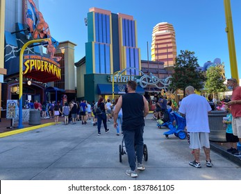 Orlando,FL/USA-10/18/20: People Walking  In Front Of The Marvel Area At Universal Studios Resort Theme Park Wearing Face Masks And Social Distancing Due To The Coronavirus Pandemic.