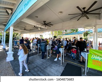 Orlando,FL/USA-12/25/19: The Entrance To SeaWorld Orlando Theme Park Where Employees Scan The Guests Tickets And Check Photos On An Electronic Device Prior To Allowing Them Into The Park.