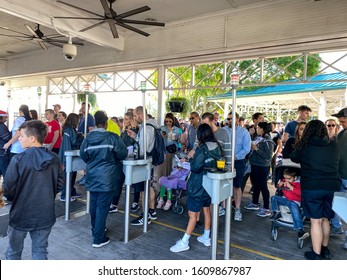 Orlando,FL/USA-12/25/19: The Entrance To SeaWorld Orlando Theme Park Where Employees Scan The Guests Tickets And Check Photos On An Electronic Device Prior To Allowing Them Into The Park.