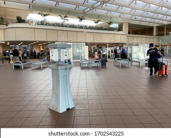 Orlando,FL/USA-3/21/20:  People Going Through Orlando International Airport MCO TSA Security On A Slow Day Due To The Coronavirus With A Hand Sanitizer Station On The Way To The Gate.