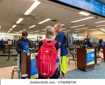 Orlando,FL/USA-3/21/20:  People Going Through Orlando International Airport MCO TSA Security In Masks On A Slow Day Due To The Coronavirus.