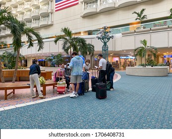 Orlando,FL/USA-3/21/20:  People In Masks Waiting To Go Through Orlando International Airport MCO TSA Security On A Busy Day.