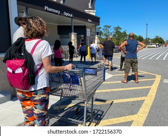 Orlando,FL/USA-5/2/20: Customers Standing In Long Lines Waiting To Get Into  A Sams Club In Orlando, Florida Due To The Hoarding Of Food And Supplies During The Coronavirus COVID-19 Pandemic.