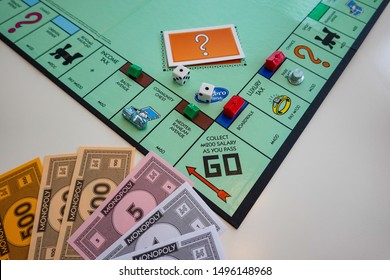Orlando,FL/USA-8/29/19: The board and pieces for the game Monopoly by Hasbro on a white background.