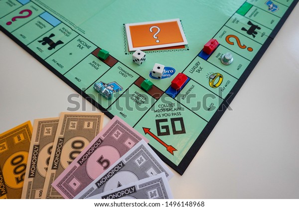 Orlando,FL/USA-8/29/19: The board and pieces\
for the game Monopoly by Hasbro on a white\
background.