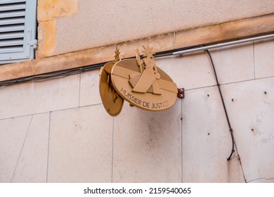 Orleans, France - JAN 21, 2022: Gold colored signboard of an usher or notary office in Orleans, France.