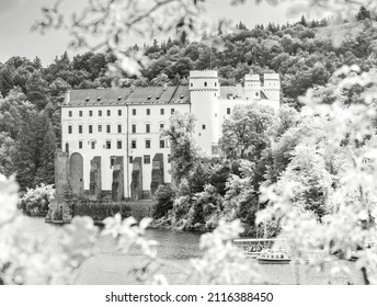 Orlik castle or chateau above water of Orlik dam. Popular Schwarzenberg medieval stronghold in the Southern Bohemia, Czech Republic. BW, Black and white,