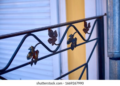 Ornament of forged leaves on a background of rolling shutters