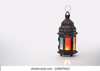 Ornamental Arabic lantern with burning candle glowing on white background. Festive greeting card, invitation for Muslim holy month Ramadan Kareem. - Shutterstock ID 1349879651